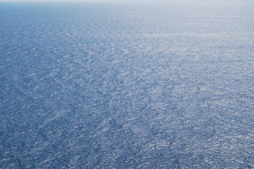 Flying seagull over blue Aegean Sea.