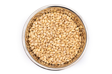 Pearl Barley from above in a stainless steel bowl, isolated on a white background. Healthy...