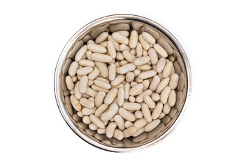 Dried White Beans from above in a stainless steel bowl, isolated on a white background. Healthy ingredient in soups and casseroles. Naturally preserved legumes with long shelf life.