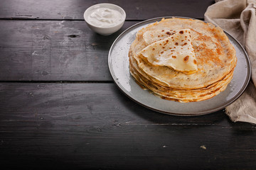 A stack of pancakes on a plate. Slavic national holiday Maslenitsa. Copy space