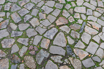 Detail of withered cobblestone plaster in medieval town
