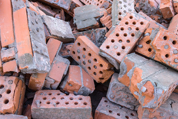 A pile of broken bricks after the demolition of a building. Landfill of old building material after...