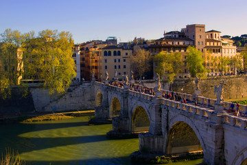 background cityscape view of the bridge of the Holy Angel and the embankment of the Tiber River in Rome, Italy, Europe