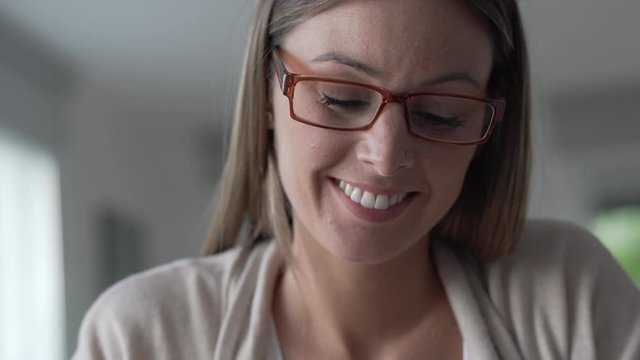 Portrait of woman with eyeglasses connected with tablet