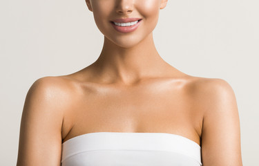 Beautiful woman teeth smile  neck shoulders lips healthy skin cosmetic tanned skin care female model - obrazy, fototapety, plakaty