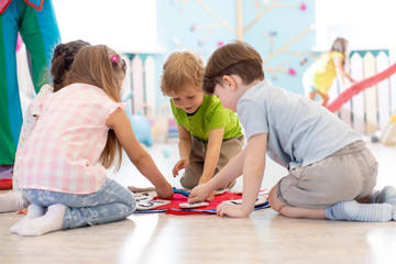 Preschool children learning how to tell time from clock and set the hands in the correct position