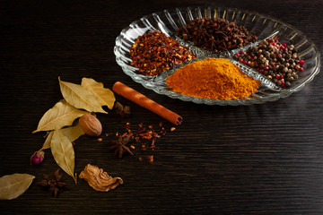 spices still life on a black wooden background