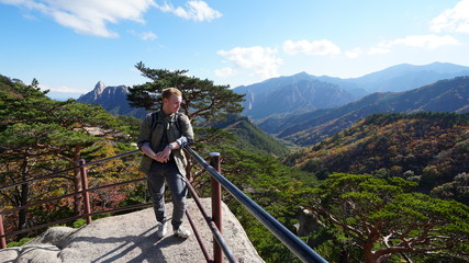Young man on the top of Ulsanbawi mountain in a Seoraksan National Park in South Korea, Asia.