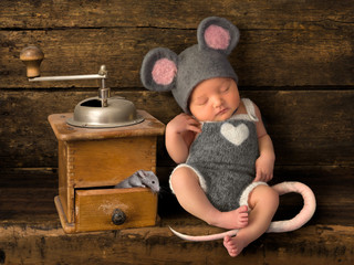 Sleeping baby dressed as mouse