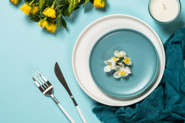Spring table setting with flower top view.