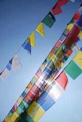 A Tibetan prayer flag is a colorful rectangular cloth, often found strung along trails and peaks high in the Himalayas. 