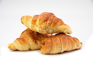 Fresh homemade croissants isolated on white background