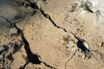Cracked old concrete road by giant drill head truck to do new road construction