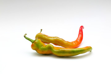 isolated red and yellow chili peppers on a white background.