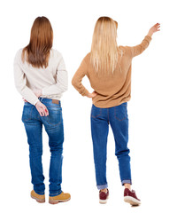 Back view of two pointing girl in sweater.