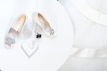 White women’s shoes and silver women’s jewelry. Wedding fashion and decor