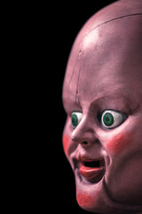 Creepy doll head in the dark