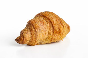 Fresh croissant made of puff pastry on a white background