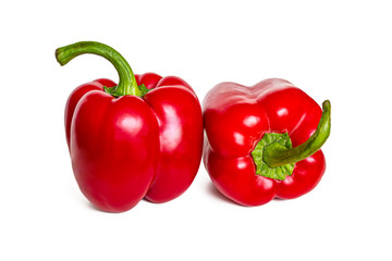 Bright, shiny red bell peppers on a white background