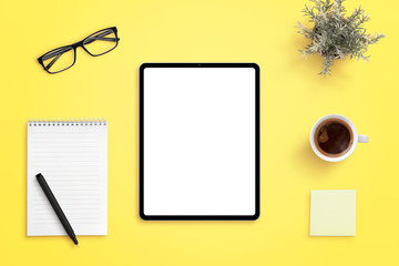 Tablet mockup on yellow office desk. Isolated screen for app or web site design promotion. Pad,...