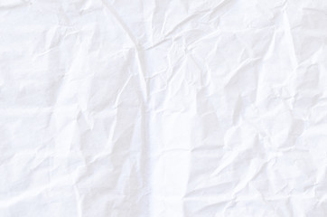 Creative background with scattered overlay of crumpled white paper.