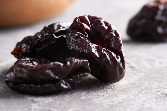 Close Up Prunes, Dried Plums On A Gray Background Rustic Style