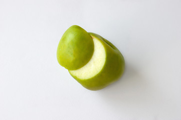 Incision green apple on white background top view.