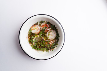 Chermoula is african cuisine mixture  of  garlic, cumin, coriander,  lemon, onion, ground chili peppers, black pepper, saffron, mint, paprika, salt, oil in pot  on white wooden background