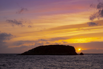 Sunrise with red sky on the beach of Es Canar, Ibiza Island, Spain