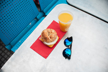 High angle cheeseburger and juice arrangement