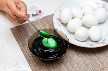 Painting eggs in the kitchen.