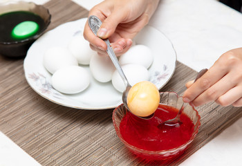 Painting eggs in the kitchen.