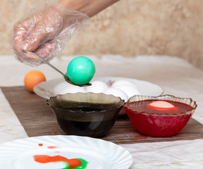 Painting eggs in the kitchen.