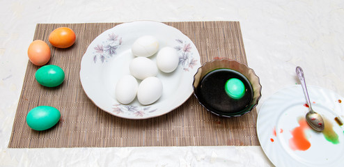 Painting eggs in the kitchen.