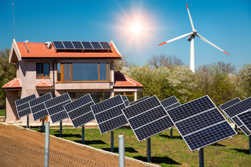 Solar panels on the roof of a family house, photovoltaics with sun tracking systems in the yard and...
