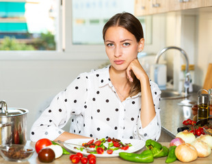 Female holding plate of vegetable salad