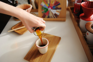 Manual brewing still life. Pouring filter coffee from decanter into cup. Bamboo board. Third wave...