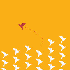 Think differently concept. Be different. Red bird changing direction. New idea, change, trend, courage, creative solution, innovation and unique way concept.	