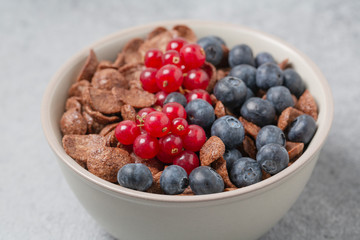 Chocolate flakes with milk, blueberries and red currants. Delicious healthy Breakfast.