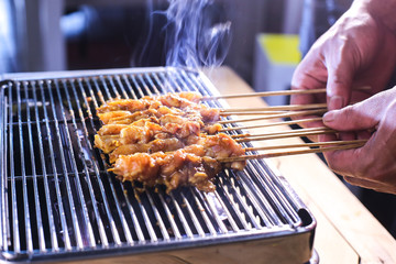 Grilling chicken skewer popular known among Indonesian as satay or sate street food