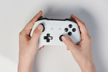 White controller with black buttons in hand