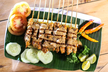 Satay are chicken meat dishes grilled in skewer and served with peanut sauce 