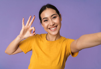 Cheerful young pretty sportswoman standing