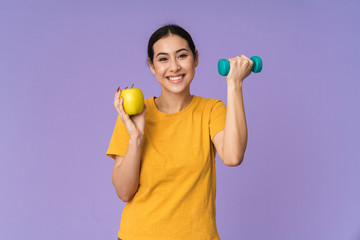 Cheerful young pretty sportswoman standing