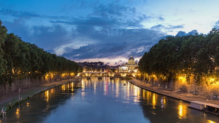 Fototapeta premium Rome, Italy: St. Peter's Basilica, Saint Angelo Bridge and Tiber River after the sunset day to night timelapse