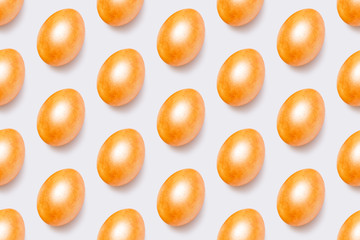 Flat lay pattern with gold eggs on blue backdrop. Creative minimal art. Holiday, easter background. Happy easter.
