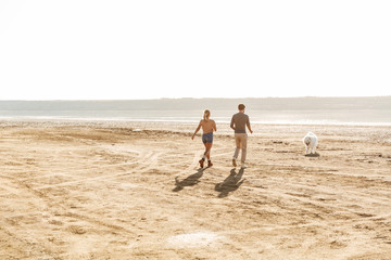 Attractive young couple playing with their dog