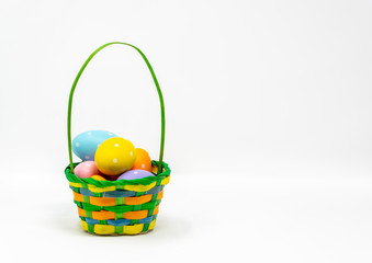 Easter Eggs in a basket with a white background