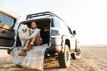 Cheerful lovely girl playing with her dog