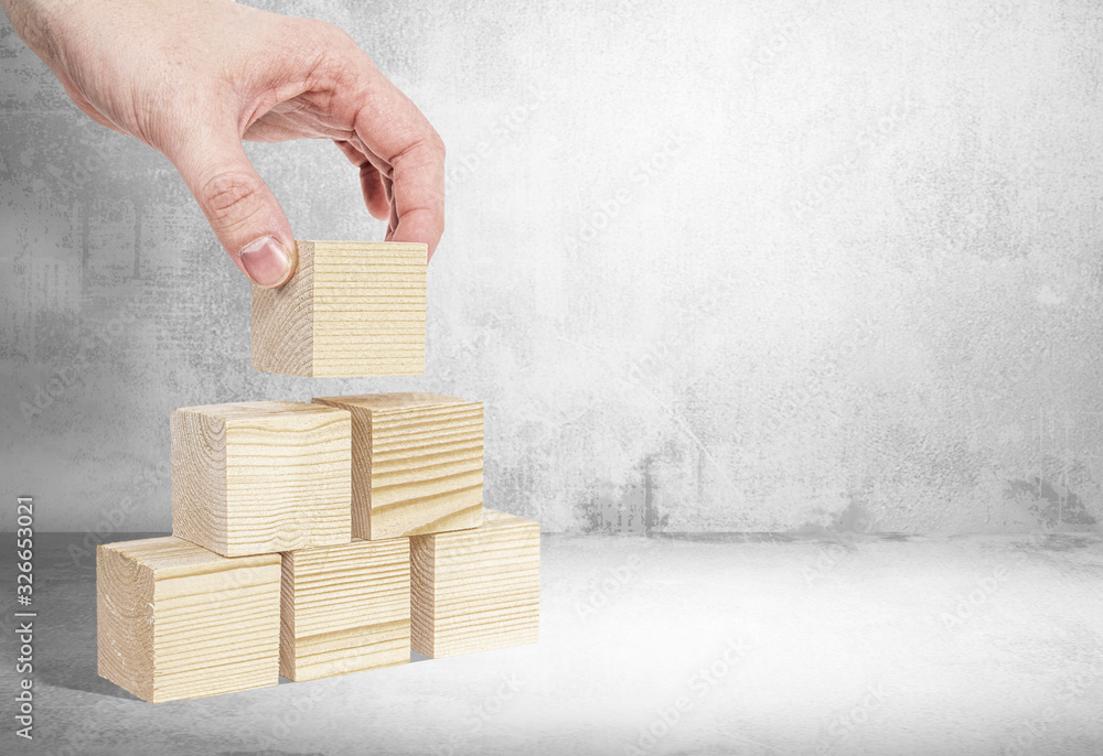 Poster stacking wooden blocks without content. business concept, content supplementation. a man arranges bl